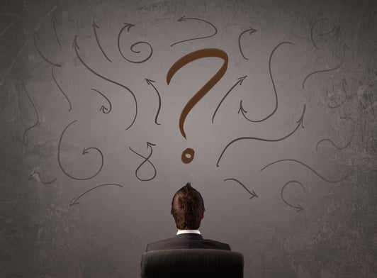 Business man looking at question mark sketch on the wall-1