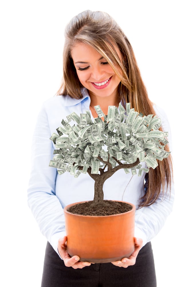 Business woman nurturing a money tree - isolated over white background