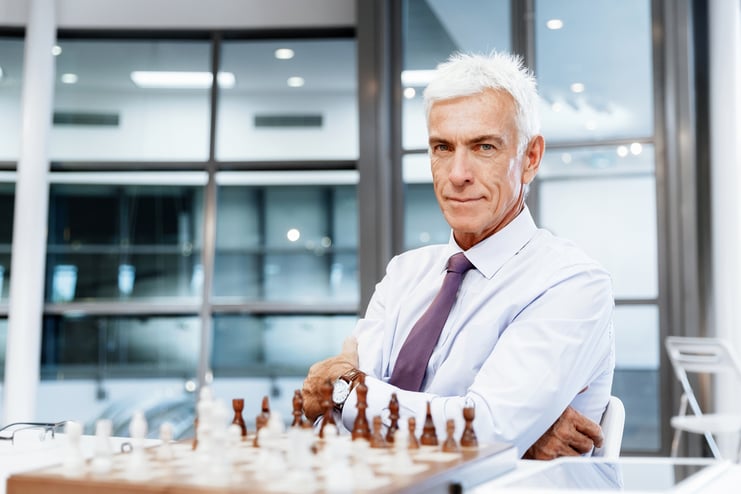 Businessman in office playing chess