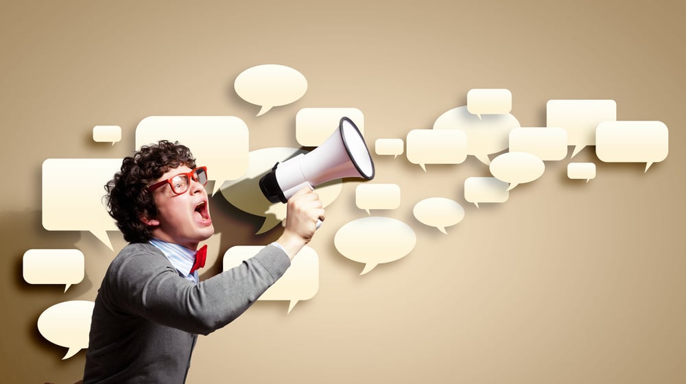 Portrait of young man shouting loudly using megaphone-1