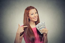 Closeup portrait super happy excited successful young business woman holding money dollar bills in hand isolated grey wall background. Positive emotion facial expression feeling. Financial reward.jpeg